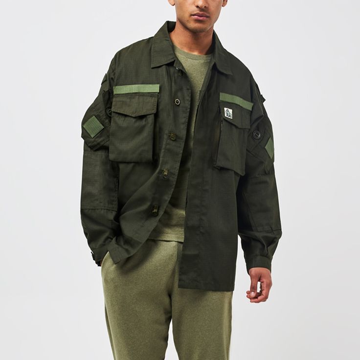 The Ranger series is part of the new AW24 Gahinga collection combining style & quality along with comfort. This piece is a re-worked outer shirt, and features a gorilla patch on the chest. It has multiple pockets, velcro patches and a waist adjustment cord.  Made from ripstop fabric, this is sourced from surplus military supply and re-worked in Greece.  Unisex item, in an oversized & baggy style. Suggested to size down.  For every item purchased, we make a donation directly to The Gorilla Organization on your behalf. Fabric-Ripstop Military Supply. Re-worked in Greece. Care instructions on label. Pre washed. Utility Tops With Patch Pockets For Streetwear, Streetwear Long Sleeve Tops With Cargo Pockets, Utility Tops With Flap Pockets For Streetwear, Long Sleeve Tops With Cargo Pockets For Streetwear, Long Sleeve Streetwear Tops With Multiple Pockets, Long Sleeve Tops With Multiple Pockets For Streetwear, Military Streetwear Shirt With Pockets, Military Style Streetwear Shirt With Pockets, Green Utility Jacket With Patch Pockets For Streetwear