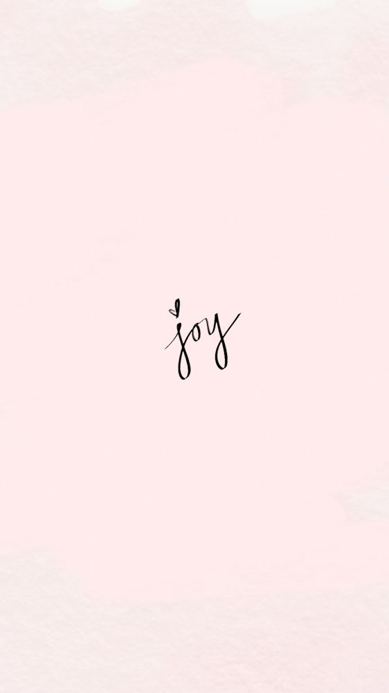 the word joy written in black ink on a pink background