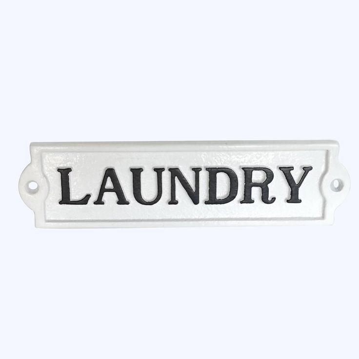 a white sign that reads laundry on it's front and back ends with black lettering