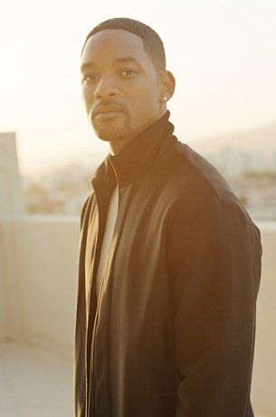 a man standing on top of a roof with his hands in his pockets and looking at the camera