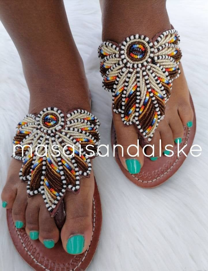 100% handmade using leather and fine beads. Masai beaded sandals are made using the pure original leather and quality African beads.They are inspired by the Masai community They are perfect for any occasion. True to size. We ship worldwide. Feel free to send me a convo for any clarifications Artisan Adjustable Sandals For Festival, Artisan Sandals For Summer Festivals, Handmade Adjustable Toe Loop Huarache Sandals, Artisan Closed Toe Beach Sandals, Artisan Open Toe Toe-ring Sandals For Summer, Artisan Adjustable Sandals For Summer, Adjustable Artisan Sandals For Summer, Artisan Toe Loop Sandals For Beach, Artisan Sandals With Single Toe Strap For Beach