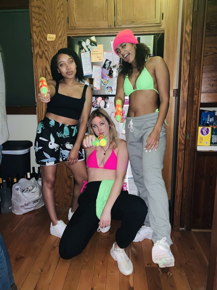 three women in sports wear posing for a photo together, one is holding an ice cream cone