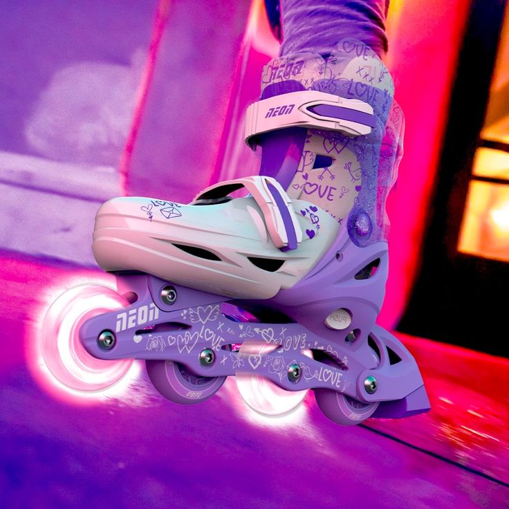 the roller skates are purple and white with blue lettering on them that says love