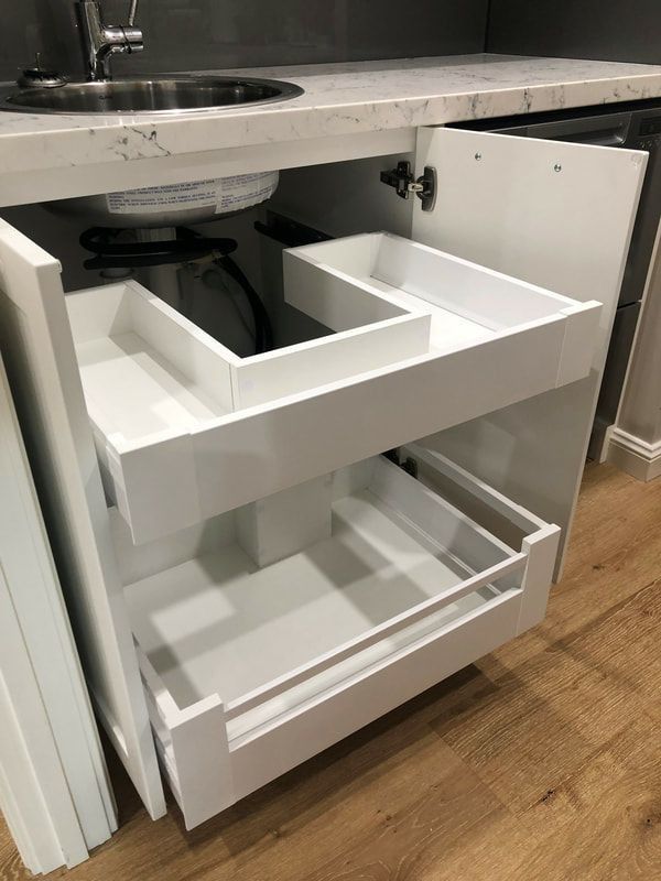 an open drawer in the middle of a kitchen