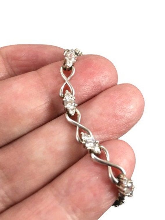 Beautiful Sterling Silver CZ link bracelet. Lovely sparkling stones prong set . Signed 925 CII China. Classic design. Measures 7" and has a slide safety clasp. Condition is very good. This is a beautiful bracelet and perfect for a special occasion. Dainty Sterling Silver Wedding Bracelet With Cubic Zirconia, Dainty Sterling Silver Cubic Zirconia Bracelet For Wedding, Wedding Bracelets With Sparkling Stones In Sterling Silver, Dazzling Sterling Silver Bracelets With Diamond Accents, Dazzling Sterling Silver Bracelet With Sparkling Stones, Sterling Silver Tennis Bracelet With Diamond Accents, Silver Infinity Jewelry For Anniversary, Diamond Bracelets With Handset Stones As Gift, Diamond Bracelet With Handset Stones For Gift