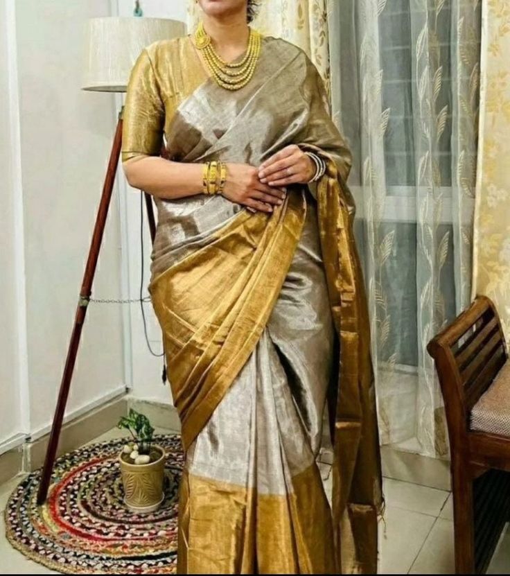 Step into the realm of timeless elegance with our Golden Grayish Silk Saree, meticulously handwoven in pure silk Chanderi. Each thread tells a tale of artisanal dedication, as skilled hands craft this masterpiece over months, ensuring every detail exudes unparalleled beauty. Paired with a plain unstitched raw silk blouse, available in a spectrum of colors to complement your style. Elevate your ensemble with the option of custom blouse stitching, adding a bespoke touch to your impeccable attire. 🌟 Don't just wear a saree; own the spotlight with Poonam Sarees! 💫🛍️ Fabric: Pure Silk Colour: Same as picture Work: Handwoven Chanderi Wash Care: Dry Clean NOTE: Expect minor variations due to lighting or monitor settings. Our products are handmade, and we do not offer return, refund, cancellati Deepika Padukone Sari, Deepika Padukone Latest, Gold Silk Saree, Hands Craft, Raw Silk Blouse, Kora Silk Sarees, Blouse Stitching, Chanderi Silk Saree, Saree Trends