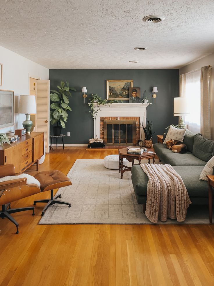 a living room filled with furniture and a fire place in the middle of a room