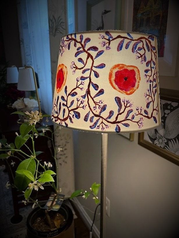 a lamp that is next to a potted plant