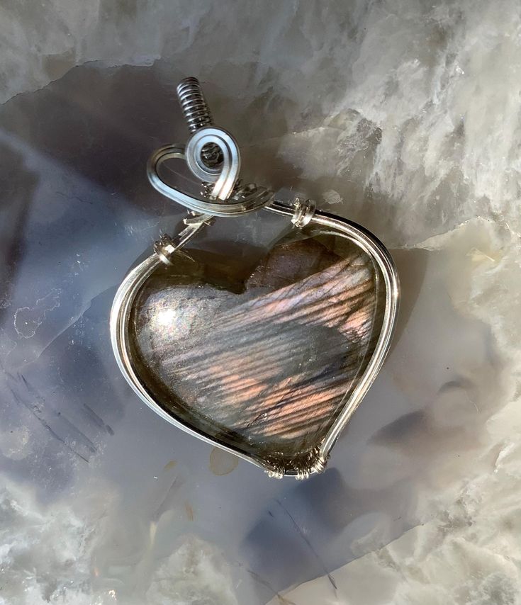 Labradorite Heart wrapped in 925 sterling silver Artisan Heart-shaped Jewelry For Anniversary, Artisan Heart Shaped Jewelry For Crafting, Artisan Jewelry With Heart Charm As Gift, Artisan Jewelry With Heart Charm For Gift, Wire Wrapped Jewelry For Valentine's Day Anniversary, Artisan Heart-shaped Gemstone Jewelry, Unique Heart-shaped Jewelry For Valentine's Day, Valentine's Day Wire Wrapped Jewelry For Anniversary, Labradorite Jewelry With Natural Stones For Gifts