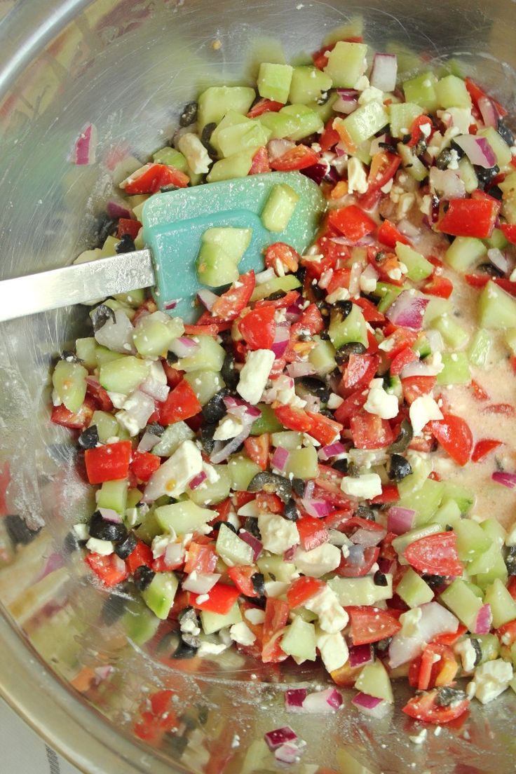 a bowl filled with chopped vegetables next to a spoon