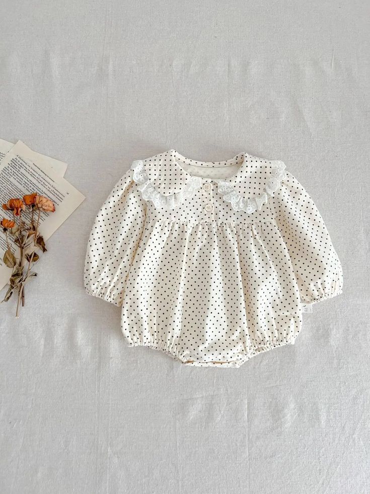 This cotton print romper is a must-have for any baby's wardrobe. With long sleeves and a ruffled collar, it provides both warmth and style. The polka dot pattern adds a touch of cuteness, making it perfect for any occasion. Give your little one the ultimate comfort and fashion with this adorable baby romper. Winter Cotton Bubble Romper With Long Sleeves, Winter Long Sleeve Cotton Bubble Romper, Spring Long Sleeve Bubble Romper For Playtime, Spring Playtime Long Sleeve Bubble Romper, Spring Playtime Bubble Romper With Long Sleeves, Cotton Long Sleeve Bubble Romper For Playtime, Cute Long Sleeve Bubble Romper For Spring, Long Sleeve Cotton Bubble Romper, Fall Long Sleeve Bubble Romper For Playtime