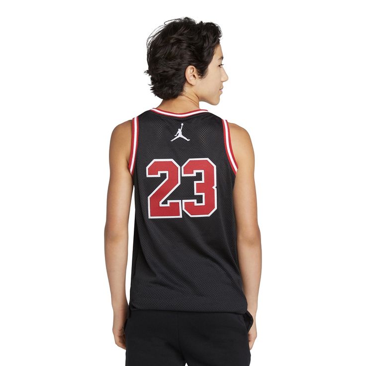 Just like Mike. The Jordan '23' youth jersey is inspired by the original so kids can feel like the legend, Michael Jordan himself. Perfect for playtime on the court or for wearing with their favorite J's. Jordan standard fit. Knit mesh fabric. Ribbed neckband and armholes. Fabric: 100% polyester. Imported. Collegiate Black Sleeveless Top, Varsity Basketball Jersey Tops, Black Team Logo Jersey For Basketball, Black Basketball Jersey With Letter Print, Black Basketball Jersey With Team Logo, Throwback Black Jersey For Sports Season, Black Casual Basketball Jersey, Sleeveless Black Jersey With Team Logo, Varsity Basketball Top With Moisture-wicking