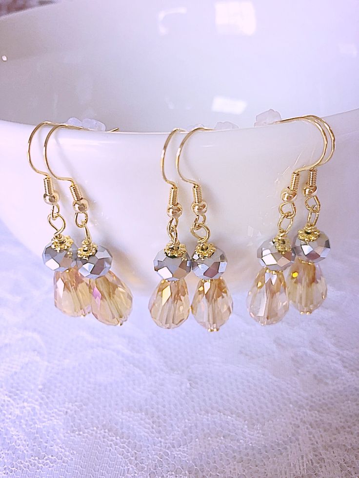 "If your wedding colors are yellow and gray, you will just love these sparkly drop crystal earrings with gold accents. These are also perfect for a jewelry proposal gift for your bridal party. They are the perfect gift for the bridesmaids, maid of honor, mother of the bride, mother of the groom, girlfriend, or just because you love yellow and gray together. The pictures don't do them justice, they are so pretty. I can also make a pendant necklace to match which would be 18\" long snake chain with this pendant.  EXTRA BONUS - This set also come with a nice gift box tied up with ribbon all ready for gifting. This set comes with a customizable gift box. You can let me know through the note to seller box when ordering what name you would like on the card in the box and what the person's title Gold Dangle Teardrop Earrings For Bridesmaid Gift, Gold Crystal Earrings For Bridesmaid Gift, Gold Crystal Earrings With Ear Wire, Gold Sparkling Dangle Teardrop Earrings, Yellow Wedding Earrings With Ear Wire, Yellow Earrings With Ear Wire For Wedding, Yellow Ear Wire Earrings For Wedding, Personalized Gold Earrings, Yellow Grey Weddings