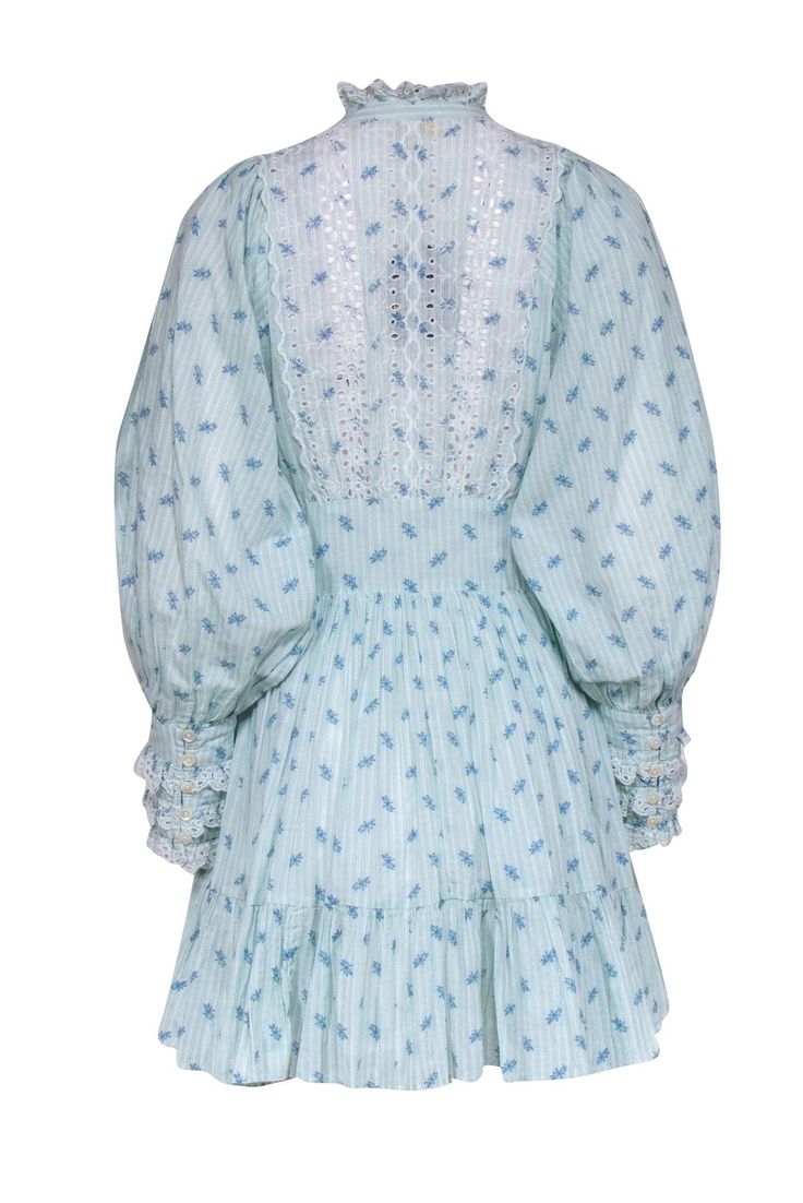 byTimo won’t have you feeling blue in this fabulous frock! Designed with vintage-inspired sleeves, a stand collar, and a banded waist this enchanting mini shows off its dainty blue floral print. Pair this with a mini cross body and sandal for a day out at the waterfront or a trip to the botanical gardens. Size XS 100% Cotton Designed in Norway Made in India Lined Skirt Invisible side zipper Button front bodice Eyelet lace detail and trims Ruffle lace collar Bust 37" Waist 28" Shoulder to hem 34. Blue Bishop Sleeve Dress With Elastic Sleeves, Blue Bishop Sleeve Dress For Summer, Fitted Dress With Bishop Sleeves And Smocked Cuffs, Fitted Dress With Smocked Cuffs And Bishop Sleeves, Blue Knee-length Dress With Smocked Cuffs, Blue Knee-length Dresses With Smocked Cuffs, Elegant Blue Dresses With Smocked Cuffs, Elegant Blue Dress With Smocked Cuffs, Blue Dresses With Elastic Sleeves For Daywear