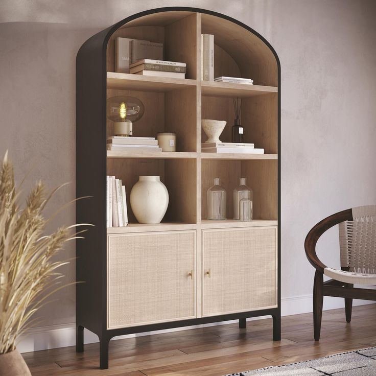 an arch shaped shelf with books and vases on it