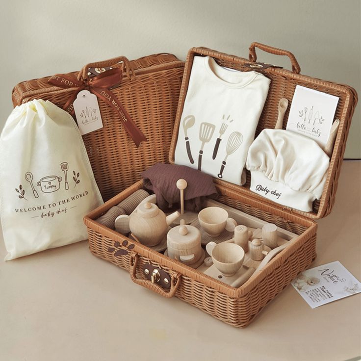 a wicker basket filled with baby items on top of a table next to a bag