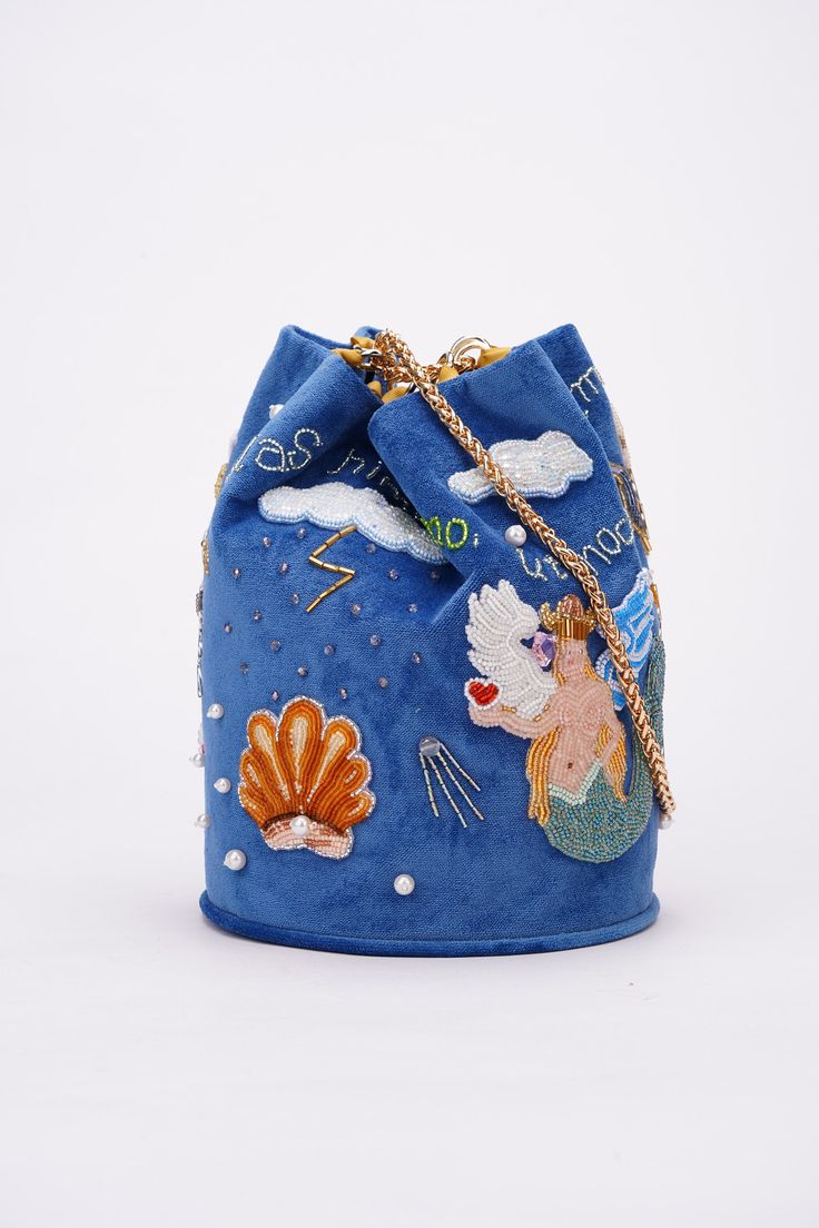 Handbag to pre-order. Production time 2-3 weeks. Bag of the purse model, made of blue velvet, on the lining. It has the shape of a bag with a rounded bottom. Hand-embroidered with Czech beads and Preciosa glass beads.  The handle is 60 cm long. The diameter of the bottom of the handbag (width) is 18.5 cm, height is 24 cm. Born of the rainbow, nurtured by the thunder, the nymph Stella develops her song. Her voice pours over the clouds and falls on the grass, flowers, trees and all living things in the form of rain drops. She has an impossible dream - to fly to the star. Not so far from it, just 10 light-years away in outer space lives an amazing shell. She knows how to show desire, but taking something in return for it.Once every 1,000 years, the conch came down to the Nymph to listen to he Designer Bucket Bag For Evening With Large Capacity, Designer Large Capacity Bucket Bag For Evening, Designer Evening Bucket Bag With Large Capacity, Designer Blue Bucket Bag With Dust Bag, Designer Blue Bucket Bag For Travel, Blue Large Capacity Shoulder Bag For Parties, Luxury Blue Shoulder Bucket Bag, Luxury Blue Bucket Bag, Large Capacity Blue Party Bag