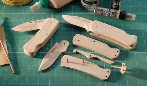 some woodworking tools are sitting on a cutting board with glue and other crafting supplies