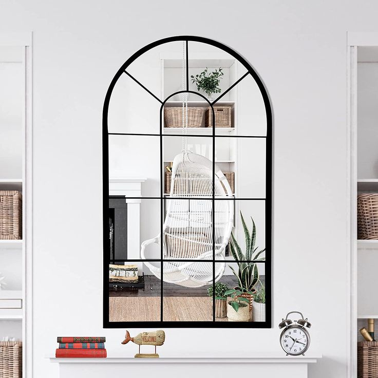 a living room filled with furniture and a fire place under a large arched window next to a fireplace