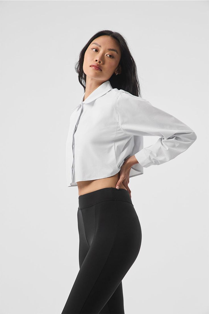 The Cropped Take Me Out Button Up is a year-round layer to wear on repeat. Made with a twill woven that’s lightweight yet warming along with hidden buttons for a sleek look, this cropped and collared long sleeve is the shacket, reimagined. Layer it over a bra top and leggings for an instant outfit that wears well anywhere. Fitted Collared Tops With Functional Buttons, Chic Fitted Cropped Shirt With Collar, Modern Collared Cropped Shirt For Work, Fitted Alo Yoga Top For Fall, Alo Yoga Fitted Tops For Fall, Chic Cropped Shirt With Collar For Work, Fitted Cropped Long Sleeve Shirt For Daywear, Fitted Cropped Blouse With Button Cuffs, Fall Layering Tops By Alo Yoga