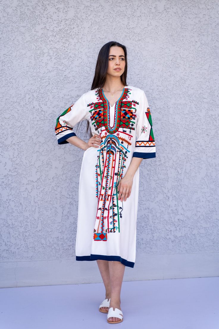 "This beautiful bohemian embroidered tunic dress is surely going to add life and oriental charm to your closet. The dress is made of Egyptian cotton which is widely renowned for its quality and texture. The dress is light and extremely soft and can be used on many occasions - beach, lounge, or even in your home to feel comfortable. Fabric : 70% Egyptian Cotton; 30% Polyester. Tunic measurements in inches : Small (Size 4/6 USA) Bust : 36-37 Hip : 40-41 Medium (Size 8/10 USA) Bust : 39-40 Hip : 45 Traditional Maxi Dress With Multicolor Embroidery, Traditional Multicolor Embroidered Maxi Dress, Traditional Embroidered V-neck Dress For Eid, Eid Straight Kurta Dress With Multicolor Embroidery, Eid Multicolor Embroidered Straight Kurta Dress, Eid Multicolor Embroidery Straight Kurta Dress, Traditional V-neck Boho Dress For Spring, White V-neck Dress With Geometric Embroidery, Eid Dresses With Multicolor Embroidery And Embroidered Border