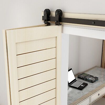 a laptop computer sitting on top of a desk next to a wooden wall mounted shelf