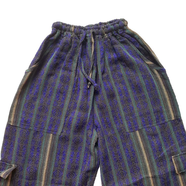 Nice comfy pants for going to the beach, camping, or spending the day at home.These hippie pants have 2 pockets on the front + 2 cargo pockets +1 pocket on the back.They are high-waisted boho pants. They have a drawstring in the waist. It was handmade by Ecuadorian artisans using the foot-treadle loom technique.Materials:75% cotton and 25% acrylic Measurements:Waist circumference: stretches from 24" up to 34"Hip circumference: 42"Rise: 11"Inseam: 28"Total Length: 39"Thigh: 12"Leg opening: 8" Car Baggy Harem Pants With Pockets For Vacation, Bohemian Bottoms With Pockets For Vacation, Bohemian Style Baggy Pants With Pockets, Bohemian Wide Leg Cargo Pants With Pockets, Bohemian Wide-leg Cargo Pants, Hippie Style Relaxed Fit Bottoms For Festival, Wide-leg Cargo Pants With Pockets For Festivals, Wide Leg Cargo Pants With Pockets For Festival, Bohemian Relaxed Fit Parachute Pants With Pockets