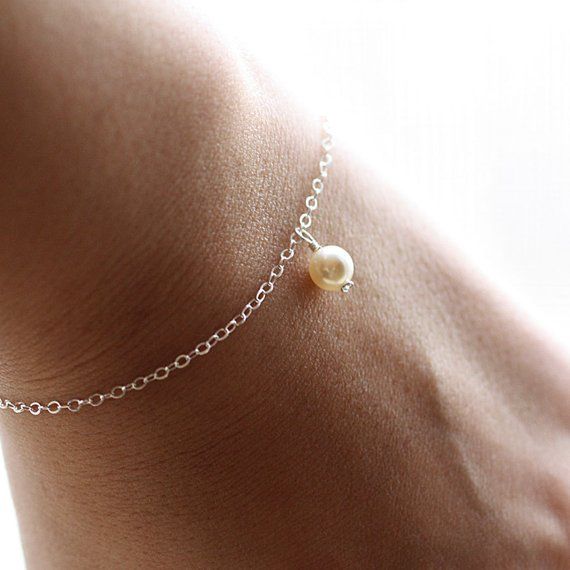 The most simple & delicate everyday bracelet. A dainty Swarovski crystal light cream pearl (6mm) floats from the most dainty & shimmering sterling silver chain. Bracelet is completed with a round spring clasp. ♥Also available in gold fill: https://www.etsy.com/listing/104812683/dainty-everyday-gold-pearl-bracelet★★Need help with your bracelet size? Please measure your wrist, and add 1/2 - 3/4 of an inch for a comfortable fit! ♥Your purchase will come thoughtfully packaged and ready for g Minimalist Sterling Silver Pearl Bracelet For Wedding, Dainty Hypoallergenic Charm Bracelet For Weddings, Minimalist Wedding Bracelet With Delicate Chain, Sterling Silver Round Charm Bracelet For Wedding, Delicate Sterling Silver Chain Bracelet For Anniversary, Dainty Silver Charm Bracelet For Bridesmaid Gift, Minimalist Adjustable Charm Bracelet For Wedding, Everyday Delicate Sterling Silver Pearl Bracelet, Dainty Sterling Silver Pearl Bracelet