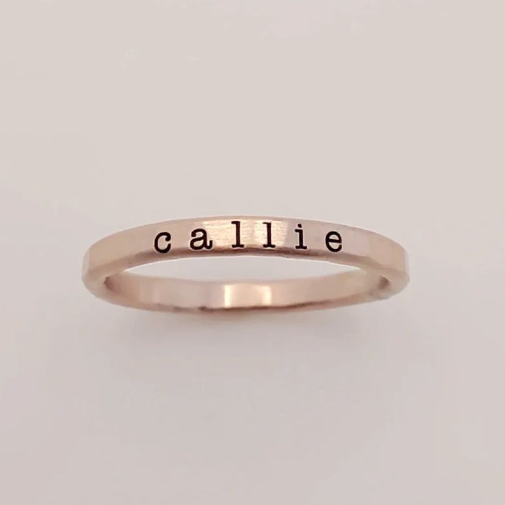 Add a touch of individuality to your jewelry collection with the Typewriter Name Ring from Going Golden. Handcrafted in Brownsburg, Indiana, this ring is perfect for those who love a classic, typewriter-style font. Available in 14K gold-filled, fine silver, or rose gold, this ring offers 100x more solid gold than plated alternatives, ensuring it’s waterproof and tarnish-resistant. Each ring comes with a polishing pad and a gift box, making it a thoughtful gift for someone special or a delightful Classic Stackable Rose Gold Initial Ring, Classic Rose Gold Stackable Initial Ring, Hand Stamped 14k Gold Engraved Ring, Classic Adjustable Initial Ring In Rose Gold, Minimalist Hand Stamped Yellow Gold Ring, Classic Engraved Rose Gold Ring For Everyday, Everyday Rose Gold Initial Ring In Sterling Silver, Classic Rose Gold Engraved Ring For Everyday, Classic Rose Gold Sterling Silver Stackable Rings