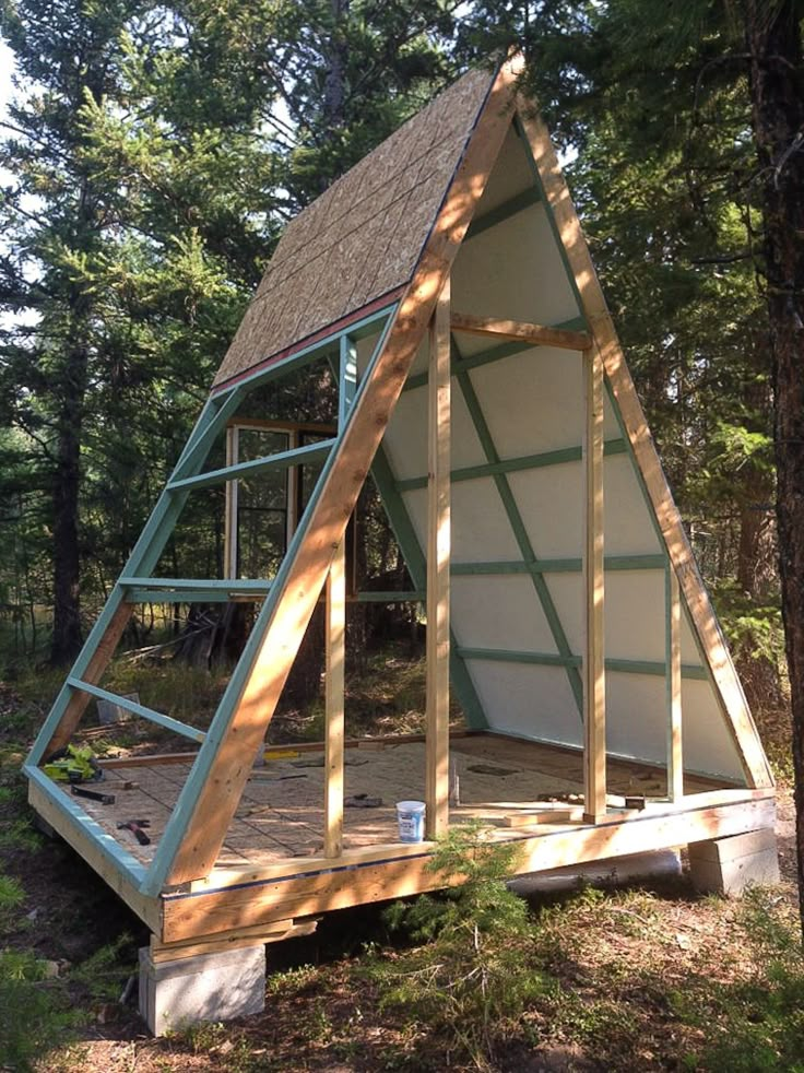 a frame house built into the side of a tree