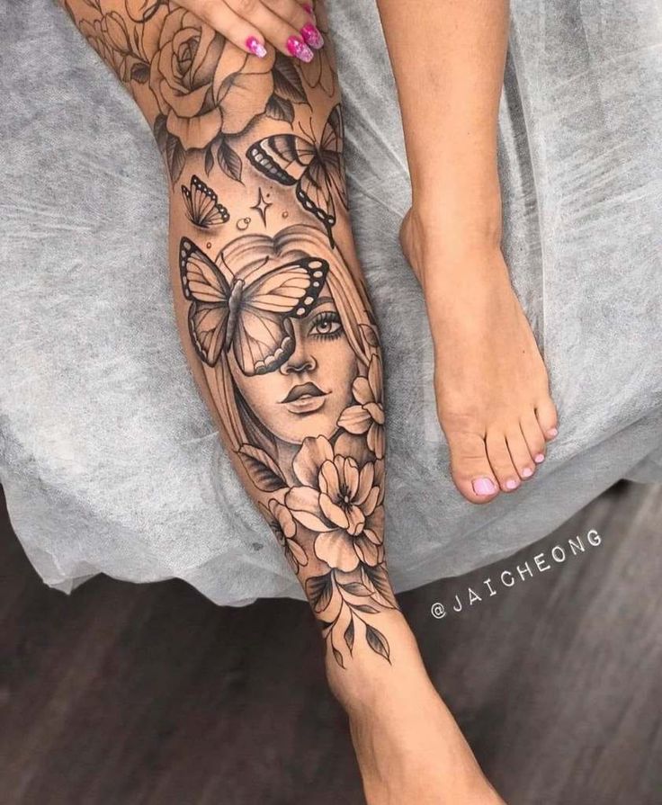 a woman's legs with tattoos and flowers on them