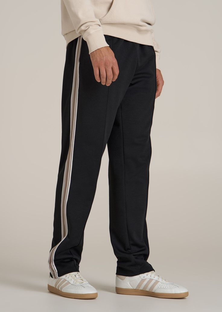 Track Pants Made for the Long-Legged Runner Hit Your Stride For the tall man who never slows down, our Tricot Extra-Long Track Pants are here to keep up. Whether you're sprinting on the track or sprinting through errands, these men's tall active pants offer the stretch and comfort you need to move freely. The mid-rise fit ensures they sit comfortably, while the internal drawstring keeps them secure. Pre-washed to maintain size and quality, these are the athletic pants for tall men you'll reach f Black Sportswear Bottoms With Side Stripes, Black Straight Leg Pants With Elastic Side Panels, Black Full-length Bottoms With Side Stripes, Black Athleisure Pants With Side Stripes, Black Full Length Bottoms With Side Stripes, Jogging Bottoms With Side Stripes, Black Relaxed Fit Bottoms For Training, Gym Pants With Side Stripes In Black, Black Gym Pants With Side Stripes