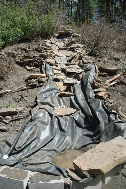 there is a long line of rocks that are laying on the ground and covered in plastic