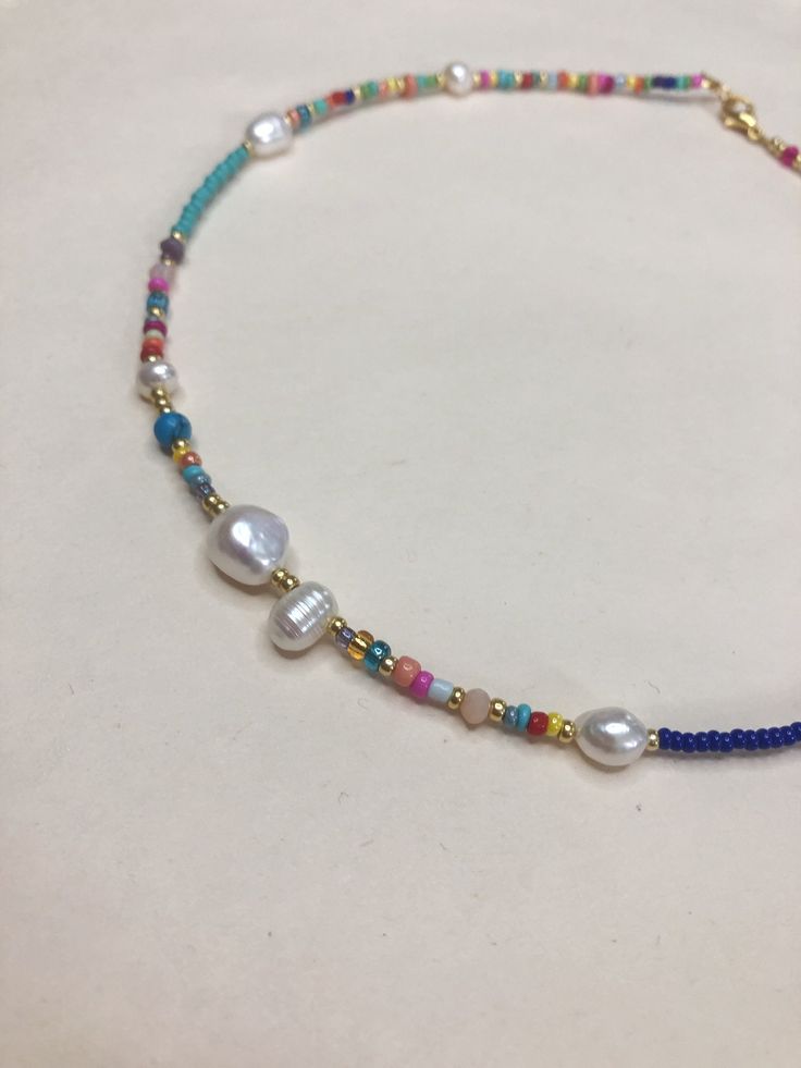 "Seed bead necklace is handmade from the best materials. You can buy a rainbow beaded necklace as a gift for a friend, sister, mother. BEADS SIZE : The pearls are 4-9mm (0.15 - 0.35 inch), and the beads are 2-3mm (0.07 - 0.11 inch). MEASUREMENTS: Choose a length for your choker necklaces (measured in inches). Measure the length of your neck with a measuring tape or you can use any thread, rope, or cable for telephone and after apply the measurements to a regular ruler. If you have any questions Bohemian Pearl Necklace With Colorful Beads As Gift, Bohemian Pearl Necklace With Tiny Beads For Gifts, Bohemian Pearl Necklace With Colorful Beads For Gift, Multicolor Bohemian Pearl Necklace With Charm, Bohemian Multicolor Pearl Necklace With Pearl Charm, Adjustable Multicolor Pearl Necklace With Tiny Beads, Multicolor Pearl Necklace With Tiny Beads And Adjustable Fit, Multicolor Pearl Beads For Gifts, Adjustable Colorful Beads Pearl Necklace As Gift