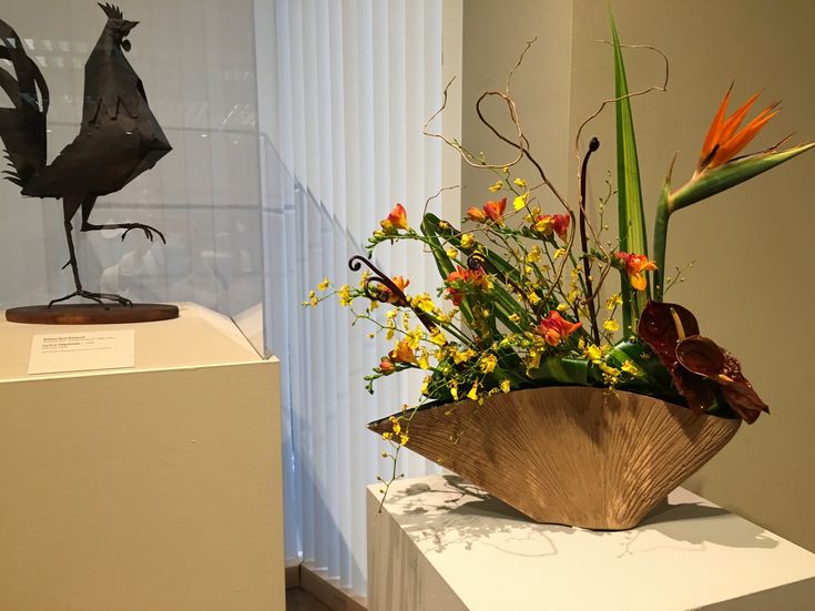 a vase filled with flowers sitting on top of a white table next to a window