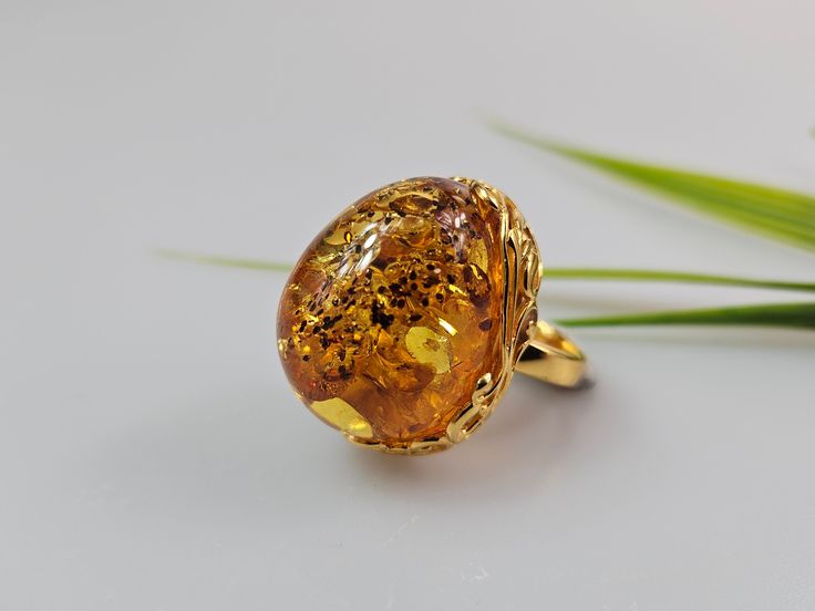 Amber ring. Brown cognac Amber. Certificated Sterling silver 925 with stamps - hallmarks. Big nice stunning ring. Adjustable size. Very big and stunning amber gemstone ring.  weight  16,82 gr GOLD plated ring.  Stone size - 3 x 2,5  cm This item was made of natural Baltic Amber. All the amber used in my jewelry is collected in my home country Lithuania.  I sell only genuine,  real, not pressed, authentic, natural Baltic Amber. Item may have natural imperfections. Formal Gold Cabochon Signet Ring, Luxury Amber Rings For Formal Occasions, Elegant Gold Crystal Ring With Cabochon, Elegant Dome Ring With Prong Setting For Gift, Elegant Dome Ring With Prong Setting As Gift, Elegant Amber Crystal Ring, Gold Cabochon Ring Fine Jewelry, Gold Cabochon Open Ring, Gold Open Ring With Cabochon