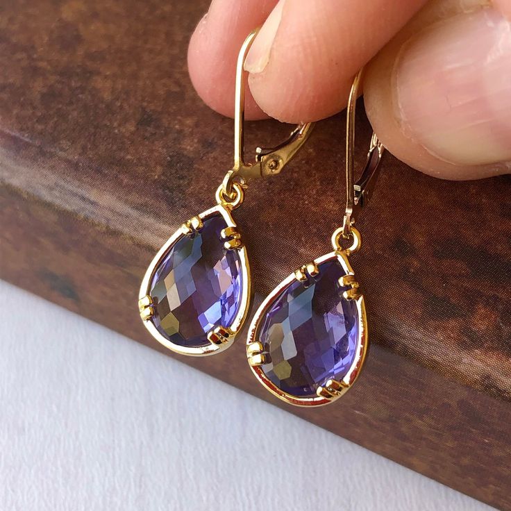 Amethyst Earrings, February Birthstone, Purple Teardrop Gem Earrings in Gold or Silver, Purple Jewelry, Lavender Earrings, Gift for women These small but gorgeous earrings feature deep purple amethyst teardrops bezel framed in either 14k gold filled or sterling silver. The teardrops are suspended form lever back ear wires in the finish of your choice. These are small, delicate and dainty earrings but with a gorgeous lavender color sure to match many outfits. Ideal for a girl or a women that like Purple Jewelry Set, Lavender Earrings, Amethyst Birthstone, Silver Gift Wrap, Gem Earrings, Purple Jewelry, Amethyst Gem, February Birthstone, Earrings In Gold