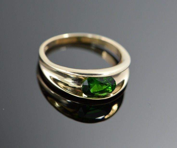 This is a 14K Yellow Gold ring with channel set green stone, oval shape, Modern, stone approximately 8 x 10 mm, Ring Size 8, Weight 4.1 grams. Stock # BB93R26 This listing contains photographs of the actual item you will receive. Our items are in excellent condition with little or no signs of wear and many are one of a kind pre-owned estate finds. Please look closely at the pictures in this listing as they are part of the product description. Please read the description, as any imperfections or Green Stone Rings, Bezel Set Ring, Channel Set, Oval Shape, Green Stone, Bezel Setting, Yellow Gold Rings, Stone Rings, Gold Rings