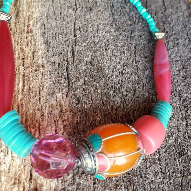 This Boho necklace has striking turquoise and pink beads, with a touch of amber on the focal bead. An unusual, colourful piece, great for a gift for your Mum, partner or friend. New Taiwanese amber bead ( focal bead ).  New turquoise acrylic seed beads. Repurposed big pink acrylic beads.  Repurposed big pink plastic crystal. Repurposed turquoise beads. Repurposed metal beads. New silver, antique look toggle clasp. Approximately 45 cm long. The idea for my hippy necklace, evolved from the gorgeous Taiwanese bead I bought, whilst on holiday. Finding charity shop ones I already had to compliment it's colours. I absolutely love it 😍. Great for day or evening wear.  Each item comes in a gift box from a recycled range, ready to give as a present, or for you to keep safely. Kalung Creations guar Handmade Vibrant Red Beaded Necklaces, Handmade Vibrant Red Beaded Necklace, Vibrant Red Handmade Beaded Necklace, Unique Handmade Pink Beads, Pink Handmade Custom Beads, Handmade Red Hippie Beaded Necklace, Handmade Adjustable Pink Necklace, Festival Turquoise Necklaces With Colorful Beads, Colorful Handmade Spiritual Necklace