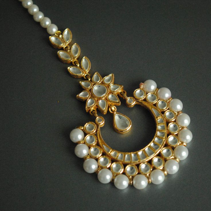 "A gorgeous cresent shaped centre piece, with kundan set stones adorned with imitation pearls. This handcrafted head gear is a must have style statement! * Stone : CZ (can me made in natural uncut flat diamonds as well. Please convo for quote) * Gold - 18k, 11 gms yellow gold * Centre piece : 2\" x 3.5\" approx * Total Length : 7.5 inches (including centre piece and hook) If you like this piece, please press \"Pin it\" button on the right of your screen. Find us on Instagram for exquisite design Ceremonial Kundan Chandbalis With Stone Work, Traditional Chandbalis With Mirror Work For Reception, Kundan Chandbalis With Mirror Work For Reception, Mirror Work Chandbalis For Reception And Festivals, Chandbalis With Mirror Work For Reception And Festivals, Festive Mirror Work Chandbalis For Reception, Festival Chandbalis With Mirror Work For Receptions, Ceremonial Chandbali Kundan Necklace With Mirror Work, White Kundan Chandbalis For Ceremonial Occasions