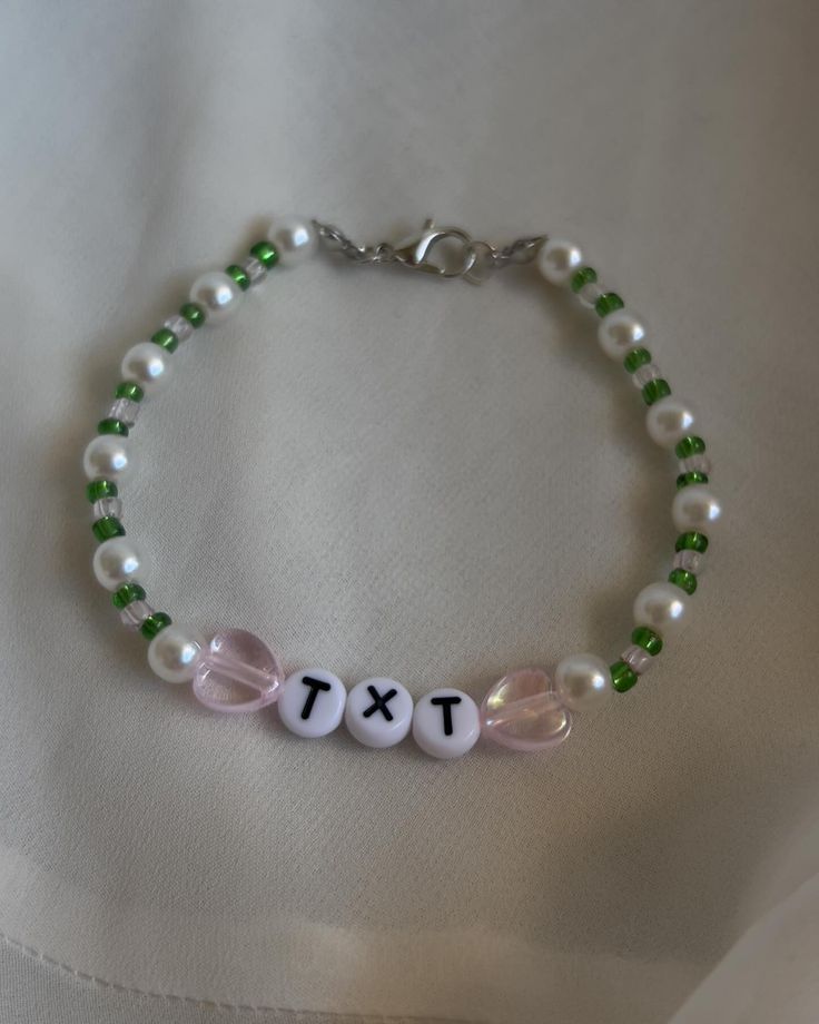 a beaded bracelet with beads and letters that spell out the word tix on it