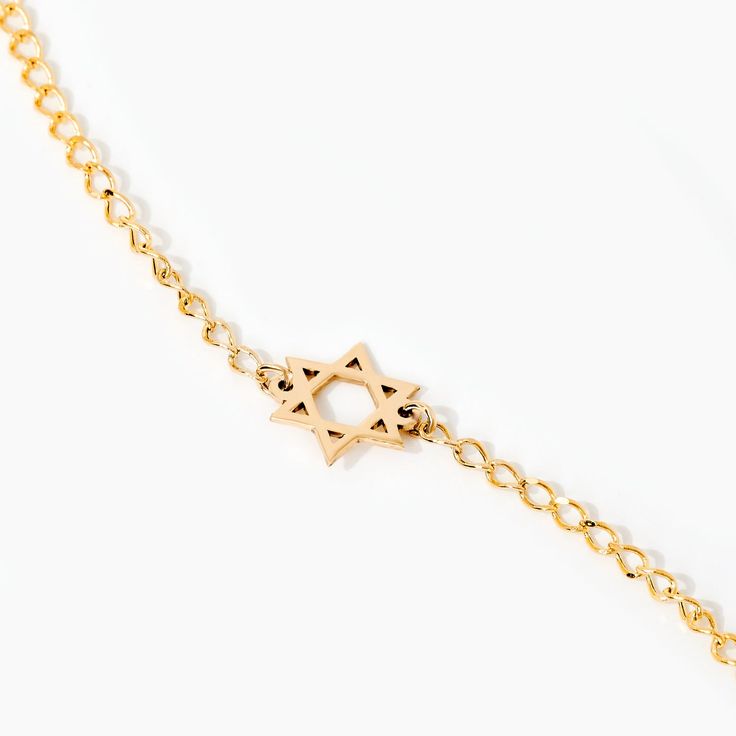 Star of David 14K Gold Bracelet This 14K Solid Gold Dainty Star of David Chain Bracelet is a timeless piece of jewelry that symbolizes faith and heritage. Perfect for elegant women, this gourmet chain bracelet features a delicate star of David, adding a sense of grace and sophistication. It's a fantastic present for the special woman in your life, showcasing beauty and devotion in its most subtle form. You'll have: 14k solid gold handcrafted pieces 100% ethical sourced jewelry Size Material: 14k Adjustable Gold Star Of David Jewelry, Dainty Star Of David Jewelry With Adjustable Chain, Yellow Gold Star Of David Jewelry With Delicate Chain, 14k Gold Bracelet With Star Charm, Classic Yellow Gold Star Of David Jewelry, Bracelet Stands, Jewish Star, Solid Gold Chains, Star Bracelet