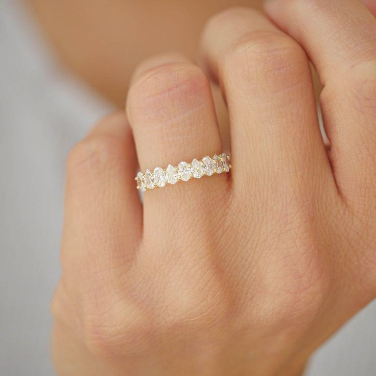 a woman's hand with a diamond ring on it