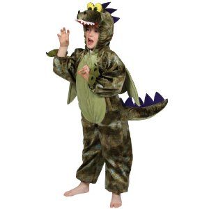 a young boy in a dinosaur costume standing on one leg and making a hand gesture