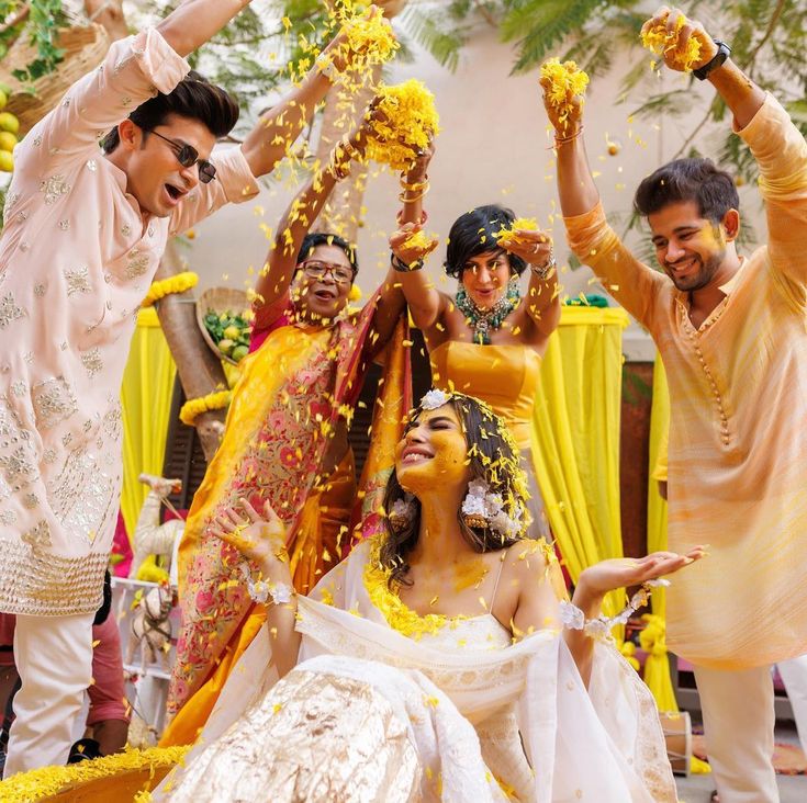 the bride and groom are throwing confetti on each other