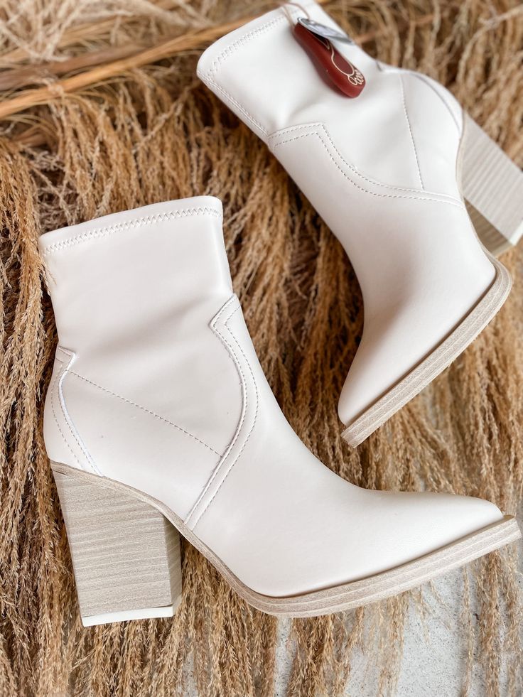 Step out in style with the Rachell Bootie! This classic neutral pointed toe bootie is the perfect finishing touch to any outfit - available in ivory or black, so you can choose the look that best suits your style. Make a statement with your footwear! Oh, and did we mention it looks amazing? 3 inch heel White High Heel Mid-calf Trendy Boots, Trendy Pointed Toe Mid-calf Boots For Spring, White High Heel Mid-calf Boots, Spring Trendy Pointed Toe Mid-calf Boots, Cream Fitted Heels For Fall, Trendy Heeled Boots With Stacked Heel And Pointed Toe, Trendy Pointed Toe Heeled Boots With Stacked Heel, Trendy Pointed Toe Heeled Boots Medium Width, Trendy Stacked Heel Pointed Toe Boots