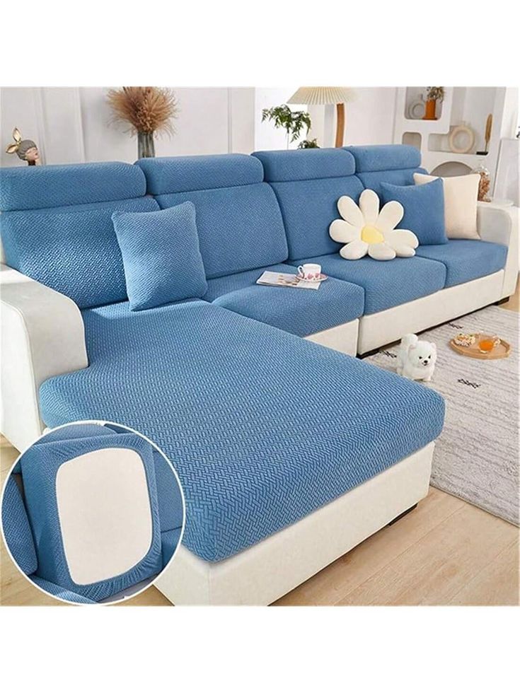 a blue and white couch sitting in a living room next to a flower on top of a table