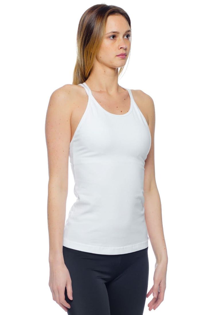 Elevate your basics with the Hard Tail Double Cross Tank. Featuring a White hue, with a high cut neckline, and a double cross design in back, this tank boasts chic style and freedom of movement. Made of a soft, flexible cotton/lycra blend fabric, with a built-in shelf bra, this tank offers comfortable style for in and out of the studio. Wear this tank for yoga, barre, gym sessions, or for everyday style. Description: High cut neckline, for full coverage. Semi-fitted. Pre-shrunk. Built-in shelf b Yoga Barre, Yoga Clothing, Simple Top, Long Torso, Cross Design, Built In Shelves, Cross Designs, Shelf Bra, Accessories Store