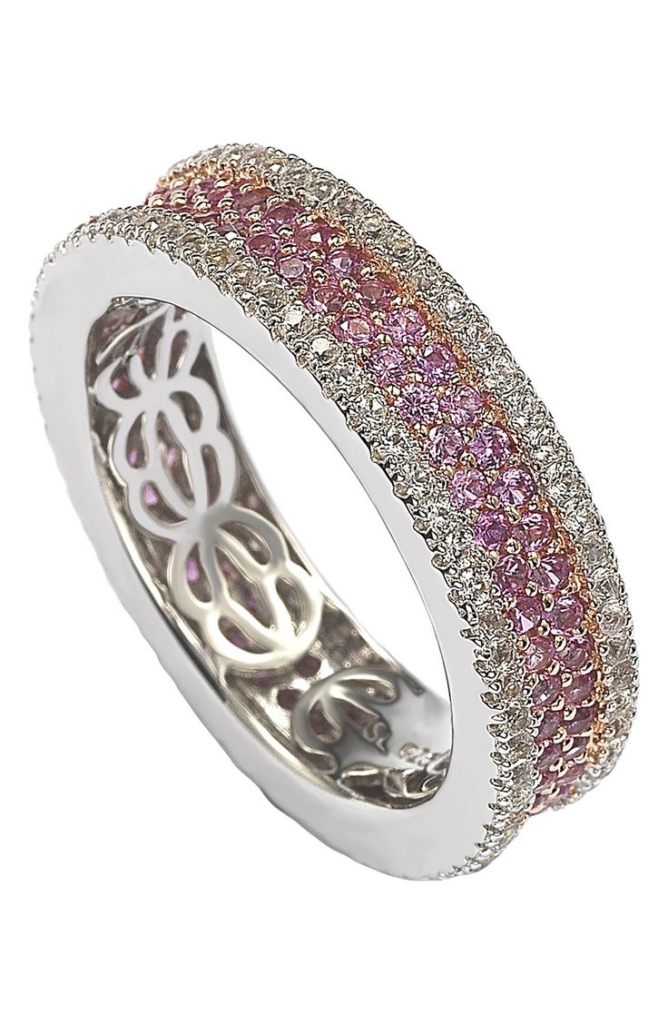 White created sapphires frame a pavé pink sapphire ring created from elegant sterling silver. Sterling silver/pink sapphire Imported Pink Brilliant Cut Round Band Jewelry, Pink Diamond Round Band Jewelry, Elegant Pink Sapphire Round Band Ring, Elegant Pink Jewelry With Pave Setting, Elegant Pink Sapphire Eternity Band, Elegant Pink Sapphire Round Eternity Band, Fine Jewelry Pink Sapphire Eternity Band With Prong Setting, Fine Jewelry Pink Diamond Ring With Round Band, Pink Diamond Ring With Round Band In Fine Jewelry