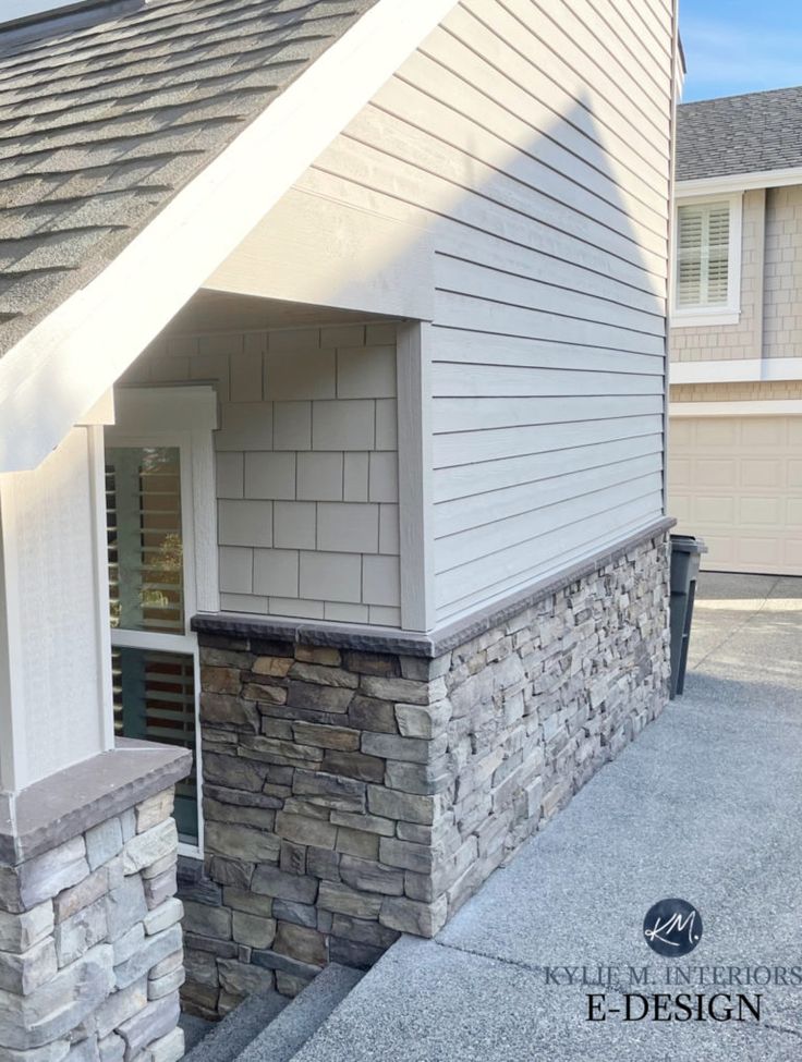 the side of a house with a stone chimney